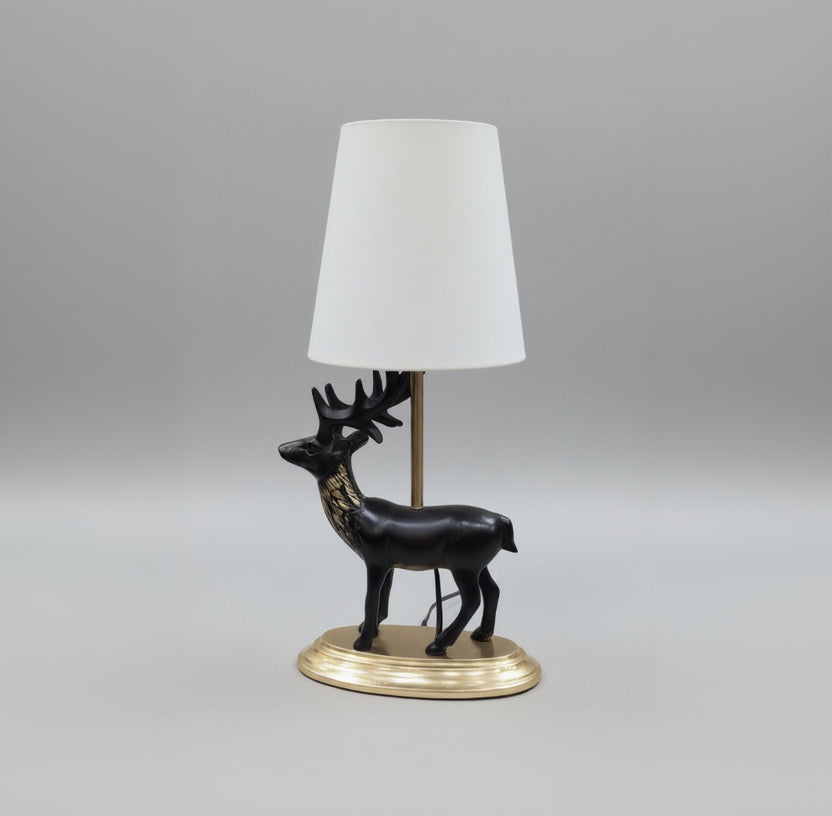 Decorative black horse figure on a pedestal with gold base, placed on a surface.