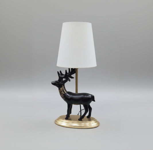 Decorative black horse figure on a pedestal with gold base, placed on a surface.