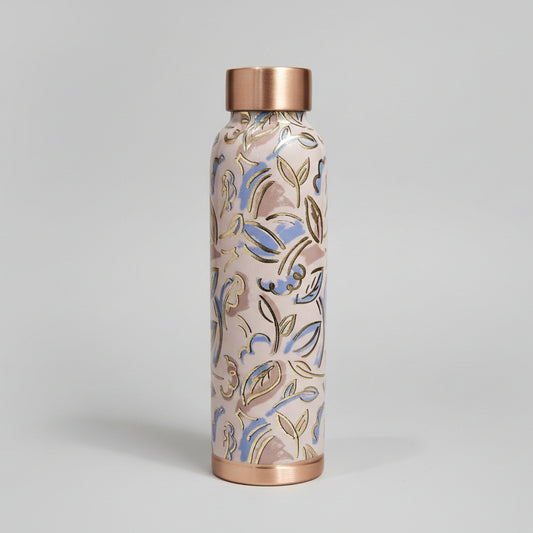 Decorative handle with floral pattern and copper accents on a white surface