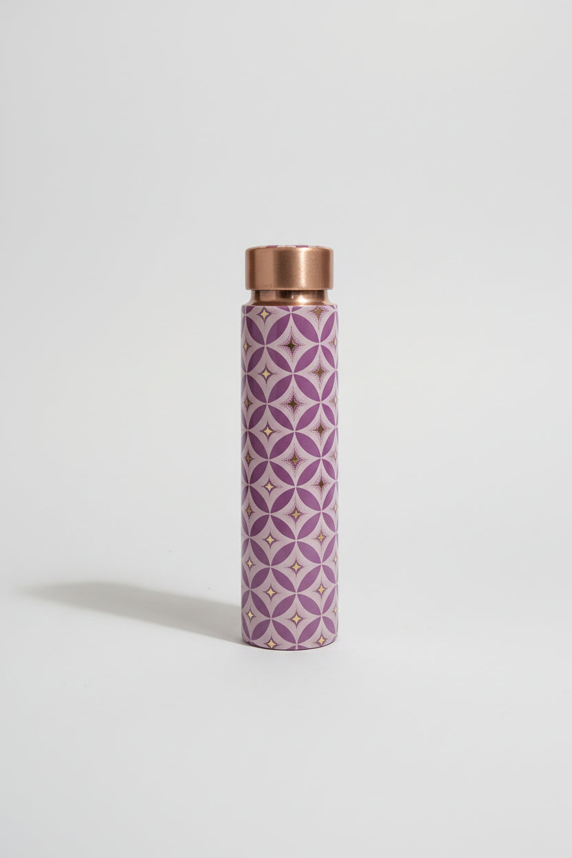 Purple patterned water bottle with copper cap on a tiled bathroom floor