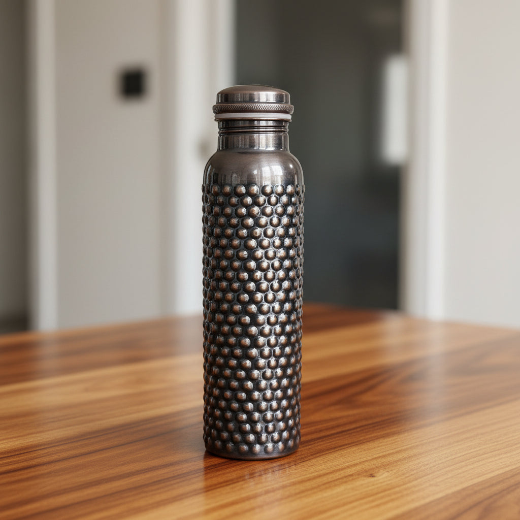 Silver textured water bottle on a white tiled floor