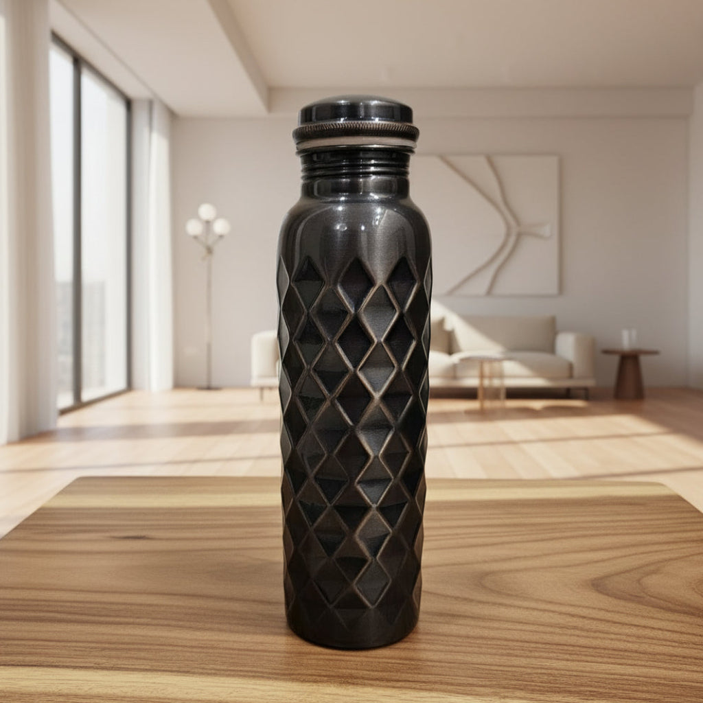 Black textured water bottle on a tiled floor