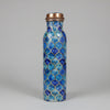 Blue patterned water bottle with bronze cap on a tiled floor