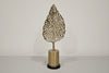 Decorative wall sconce with leaf-shaped design on a neutral background
