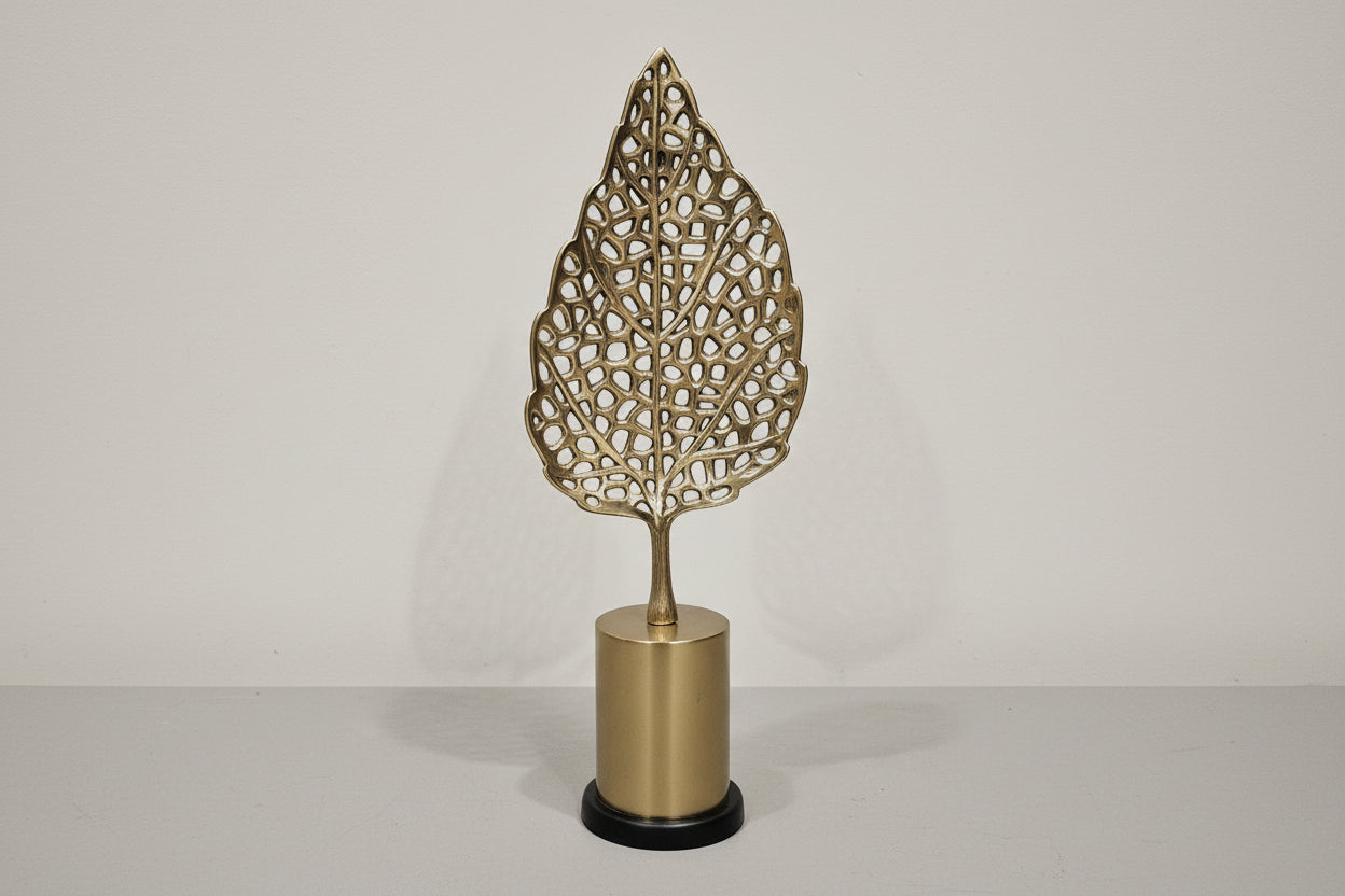 Decorative wall sconce with leaf-shaped design on a neutral background