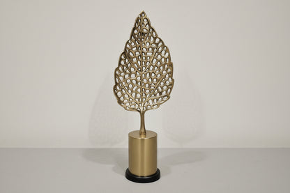 Decorative wall sconce with leaf-shaped design on a neutral background