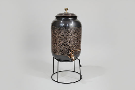 Decorative metal container with intricate patterns on a white surface