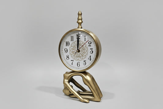 Decorative wall clock with gold hands and detailed face on a white wall.