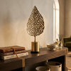 Decorative leaf sculpture on a wooden table in a cozy living room.