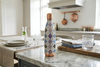 Decorative water bottle on a kitchen counter with a modern kitchen background