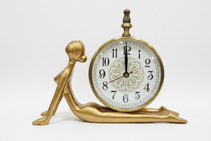 Decorative clock with a black figurine base on a white background